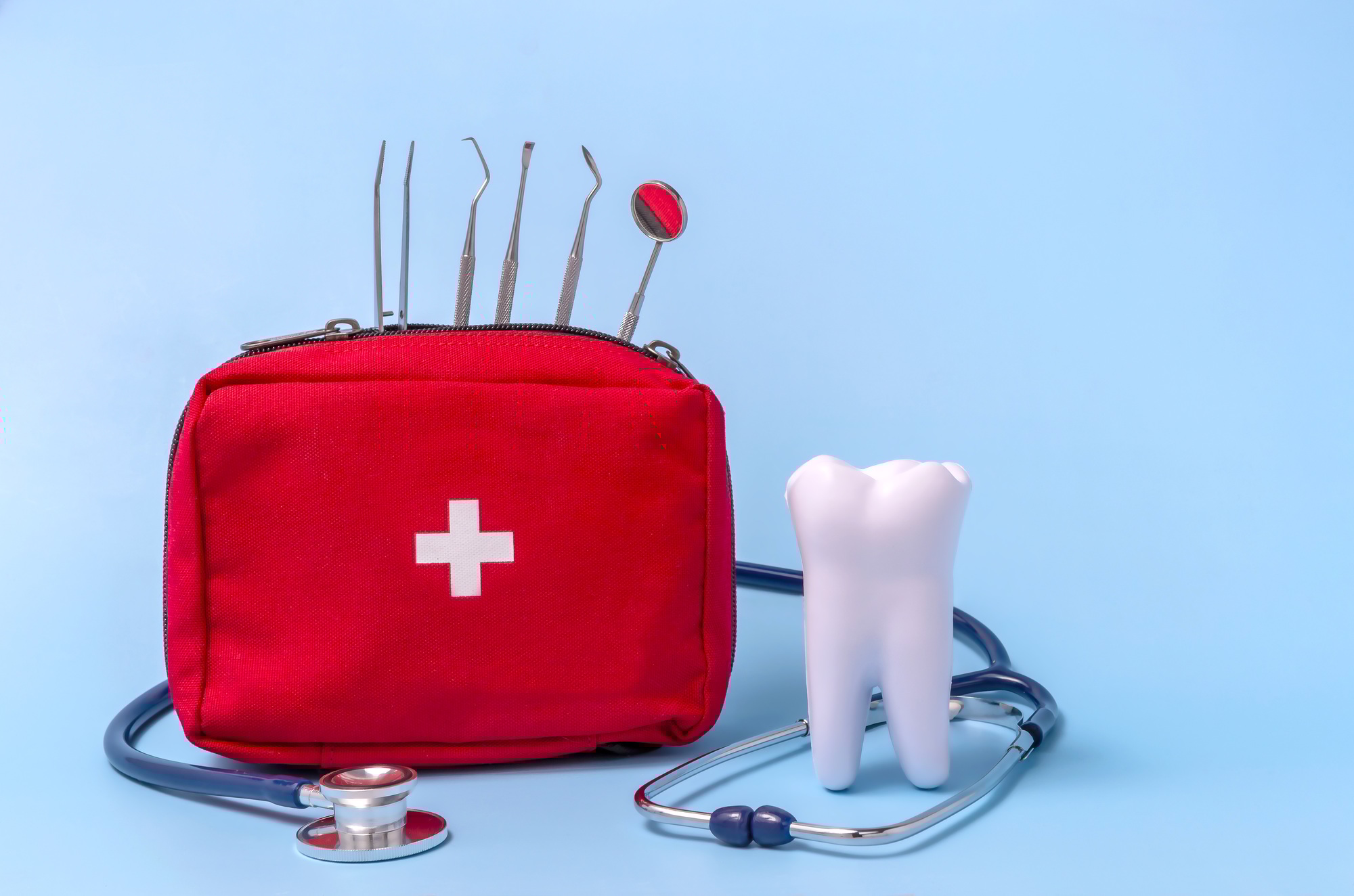 Emergency dental kit with tools, stethoscope, and model tooth representing urgent dental care at Lance Family Dental in Festus, MO